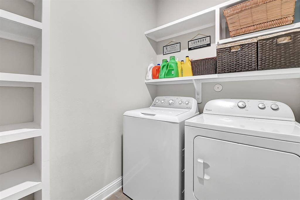 Elegant archways, iron spindled staircase, and black-walnut stained railing elevate your elevate your incredible new Beazer home. A quaint mud room can be viewed from this angle. Atop the stairs, you'll find 3 spacious bedrooms, 2 full bathrooms, a large game room, and theater room!