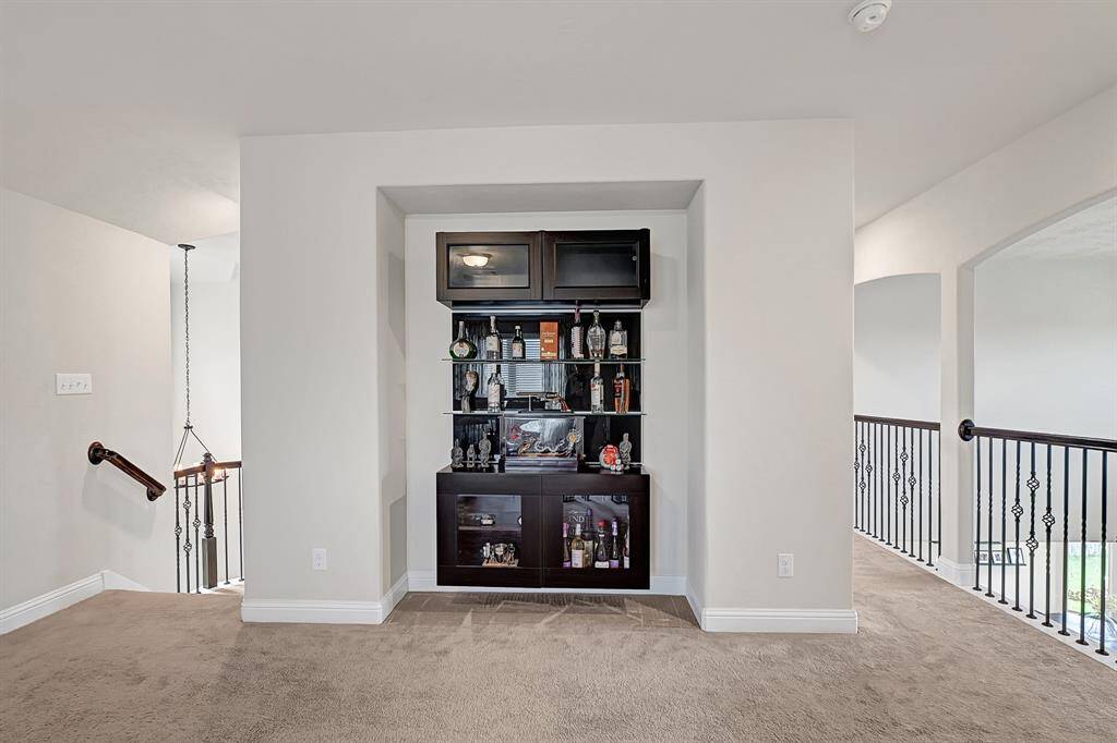 Upstairs media room designed for immersive movie nights and game day gatherings. The spacious layout offers endless possibilities for creating your own in-home theater experience.