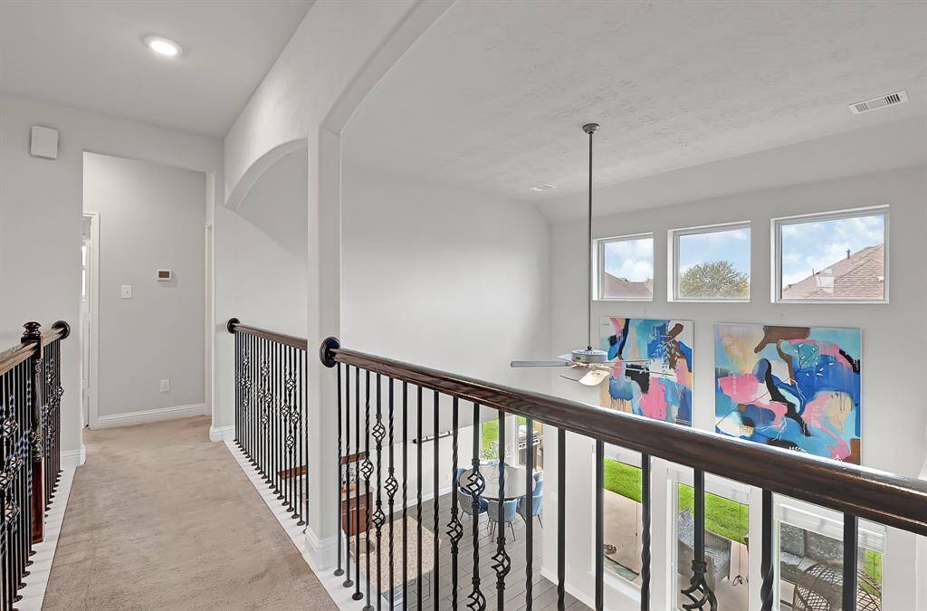 The second full bathroom, also located on the second floor, boasts grey wood-look tile flooring, neutral paint, Nutmeg vanity cabinetry, granite counters, tub/shower combo, and brushed nickel fixtures.
