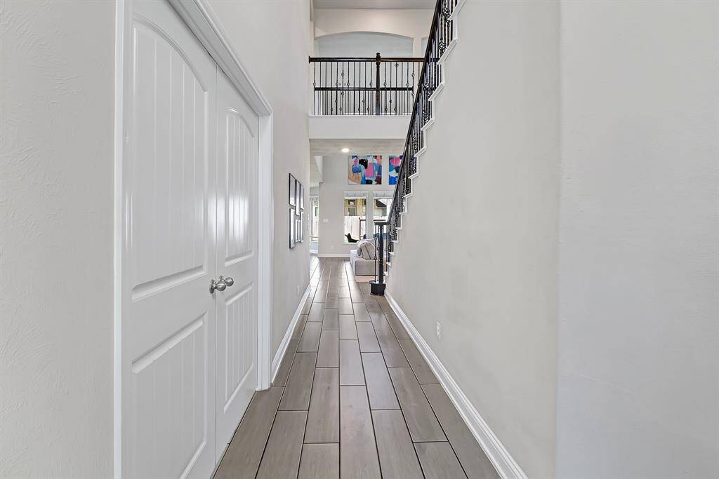Step inside the Beazer Fenway plan and you're immediately welcomed with lofty 2-story ceilings, grey wood-look tile flooring, gorgeous iron spindled stairwell and cat walk, and access into your living, dining, and kitchen areas. Through the French doors on the left, you'll find your dedicated office space.