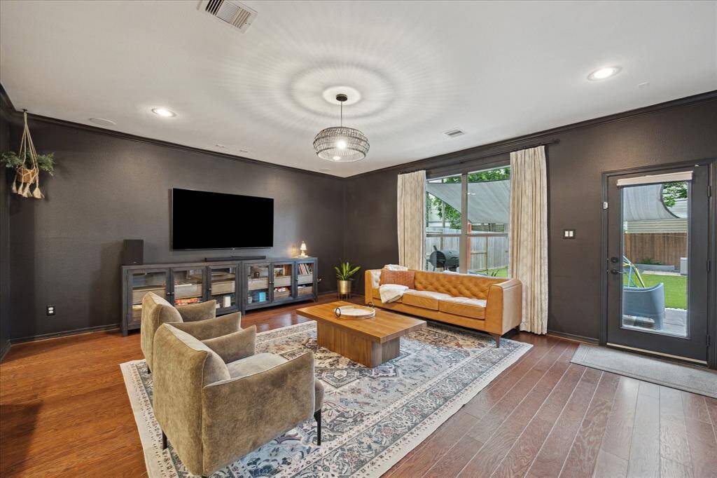 Backyard views and access from this spacious and delightfully moody living room.