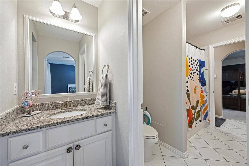 Alternate view of the shared secondary bath and second private vanity area.