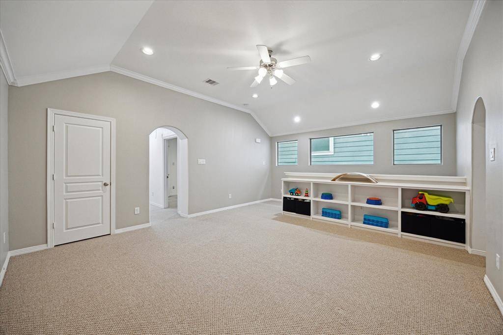 Lots of storage in this space with the build in cabinetry as well as the closet located in the left of this picture.  The arch doorway to the left of this picture is the entry toward the two secondary bedrooms.