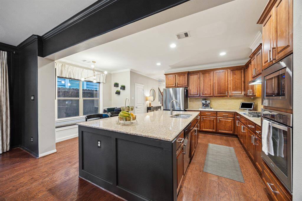 View of the kitchen back toward the entry and dining room area.  The door shown on the left of the picture is a wonderful walk-in pantry.  This kitchen is ready and well-equipped for all your culinary delights.