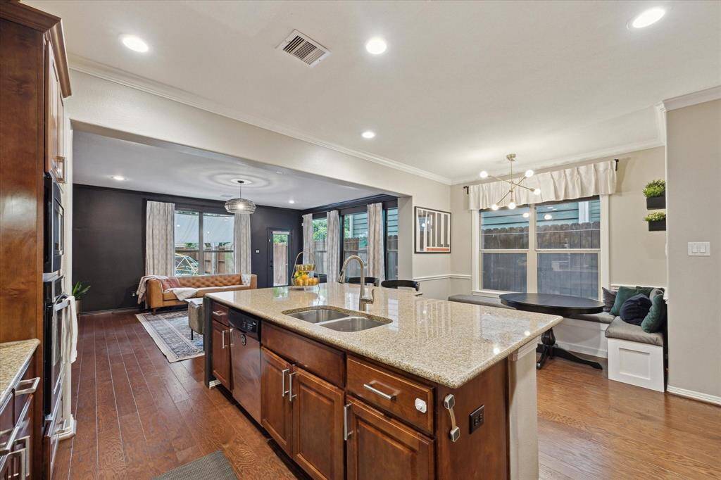 View of the kitchen toward the most precious breakfast area and chic living room.
