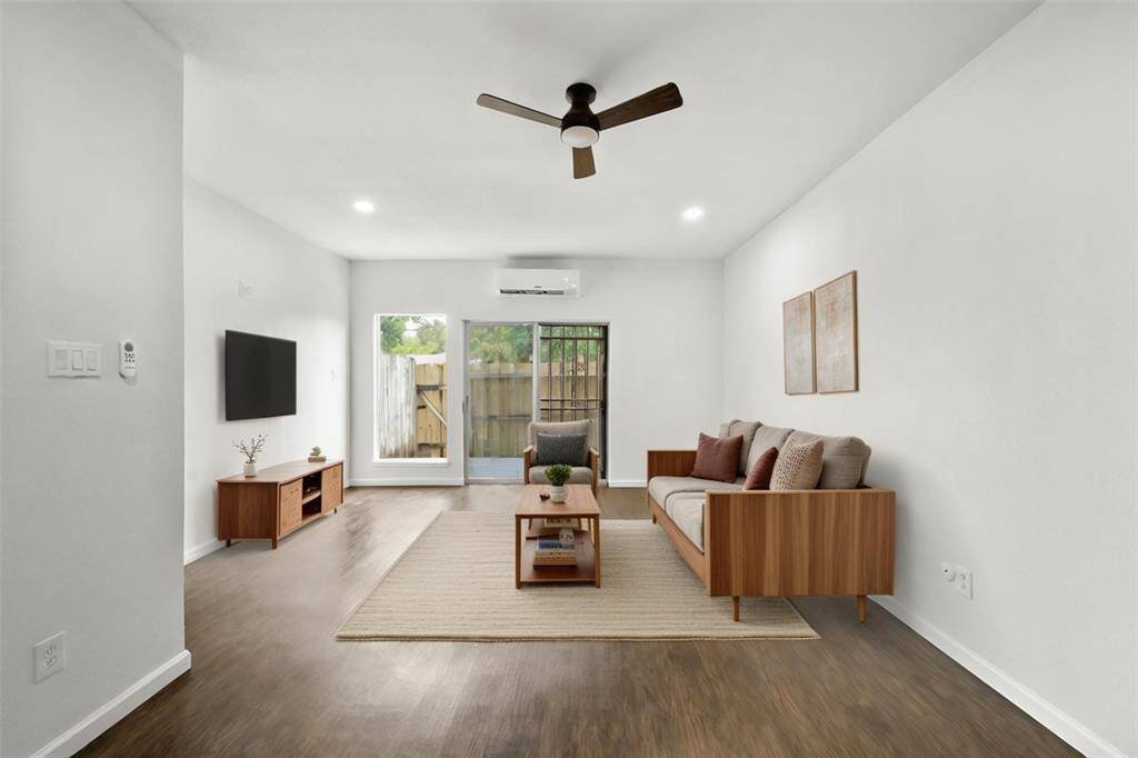 Another view of the downstairs living area leading to the back patio. Virtually staged.