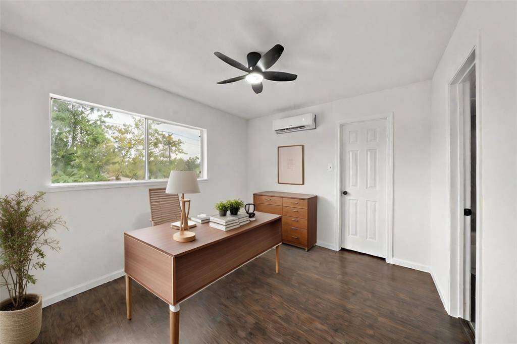 Secondary bedroom virtually staged as an office.