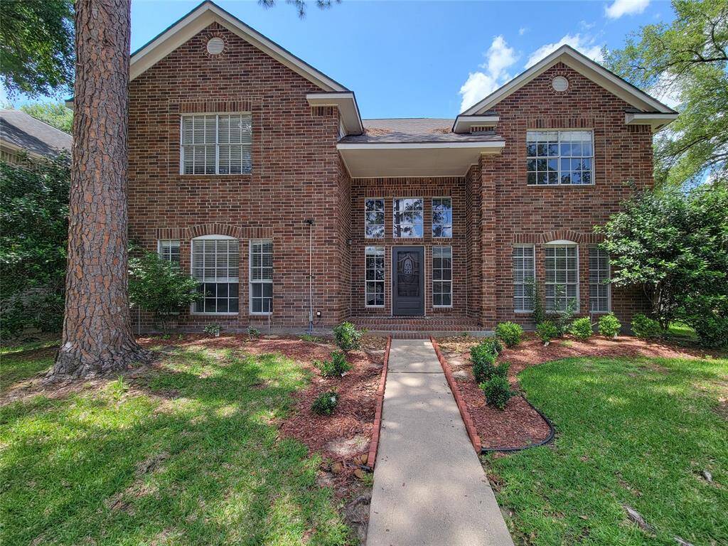 Welcome to this stunning brick home, featuring elegant architectural details and a charming front walkway. Surrounded by lush greenery, this residence offers a perfect blend of style and comfort, ready to welcome you home.