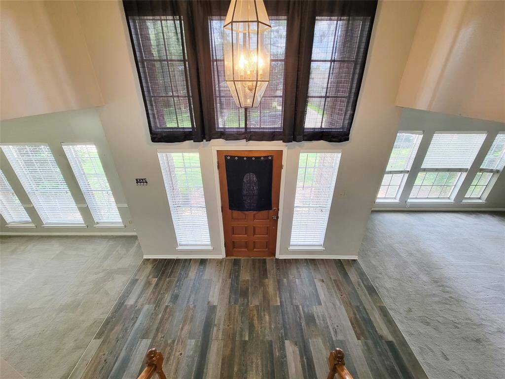 Welcome to your new home! This inviting entryway features stunning wood flooring and abundant natural light from expansive windows, creating a warm and welcoming atmosphere. Perfect for making lasting first impressions.