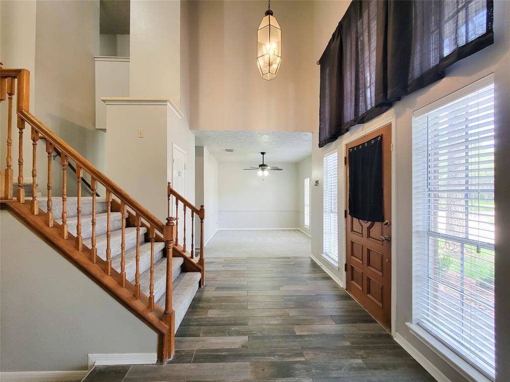 Welcome to your home! This inviting entryway features a bright, open layout with elegant wood flooring and abundant natural light. The spacious design effortlessly leads you to the living areas, perfect for entertaining or relaxing. Make this charming space yours today!