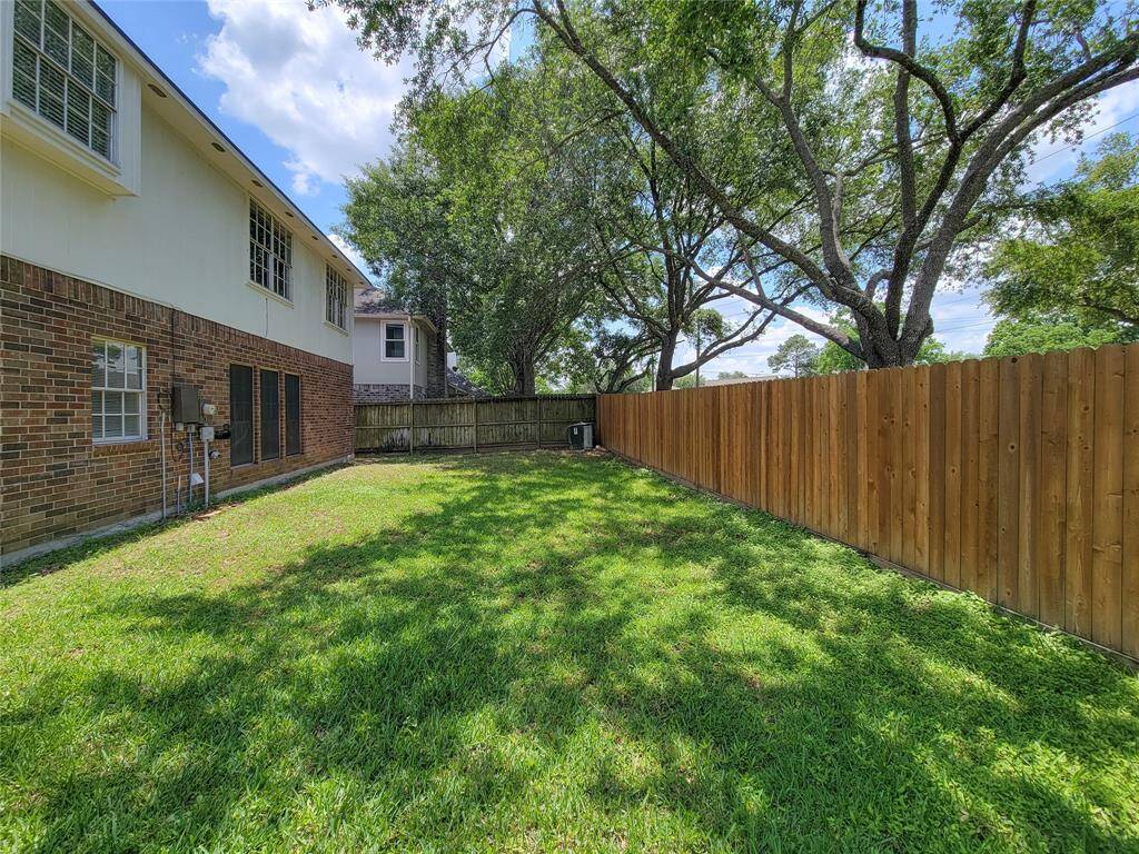 Spacious and serene backyard, perfect for relaxation or entertaining. Enjoy privacy with a sturdy fence and mature trees providing ample shade. A great space for outdoor activities and gardening.