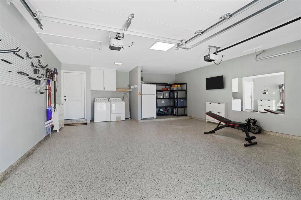 Garage was remodeled with epoxy floors and insulated garage doors.  Plenty of room for two full vehicles and laundry center.  Extra space for storage, second frig or freezer.