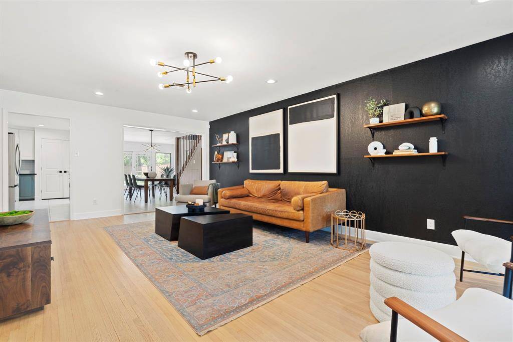 Living room with connectivity to the kitchen/dining.  Wood floors, upscale lighting.