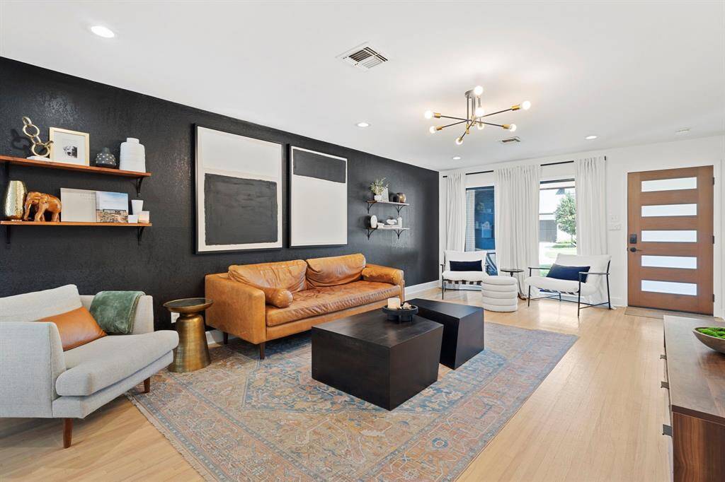 View of living room to the updated, black aluminum frame high-efficiency windows.