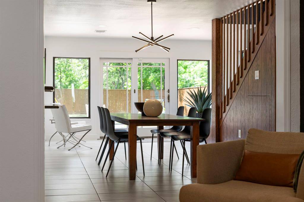 Reminiscent of Architectural Digest settings, this is the view from the living room through the dining room, sunroom onto the backyard.