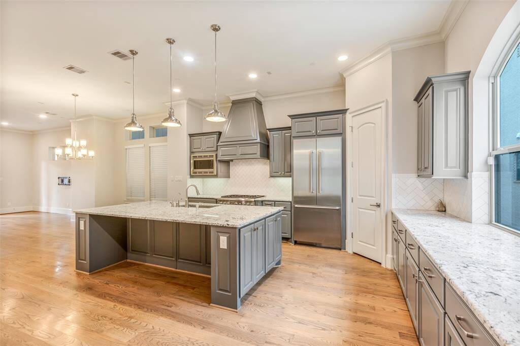 Ample cabinetry with under cabinet lighting and a large walk-in pantry complete this kitchen.
