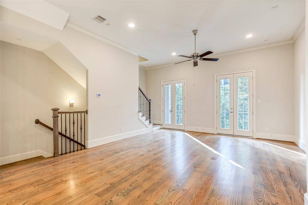 This spacious living space is bathed in the natural light from the elegant French doors.