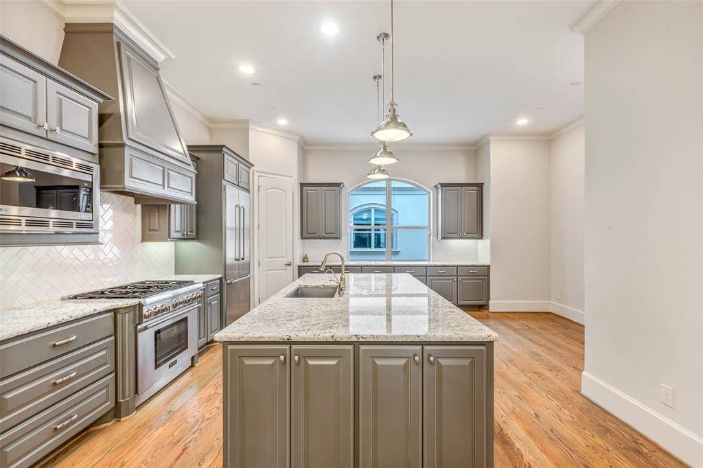 Spacious kitchen with area to be used as office space, large island and plentiful cabinets for storage