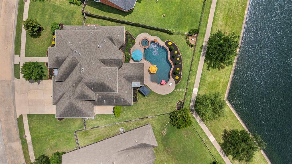 An amazing ariel view of the property backing up to the walking trail and lake.