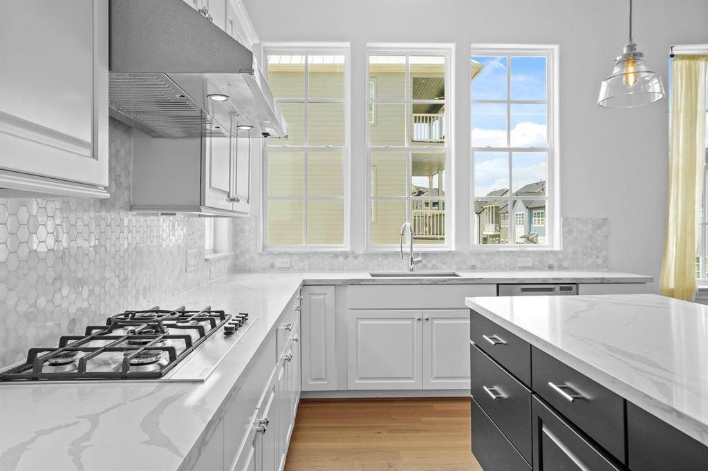 Discover a bright and expansive kitchen with ample counter space, a stylish island, and plenty of natural light.