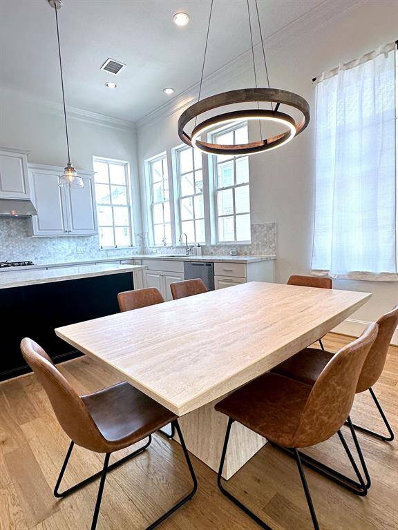 Dine in style! This open-concept space seamlessly connects the modern kitchen with a chic dining area, perfect for entertaining.