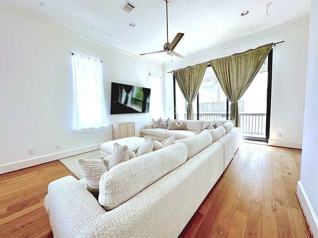 This spacious living room offers abundant natural light and direct access to outdoor living, perfect for comfort and entertaining.