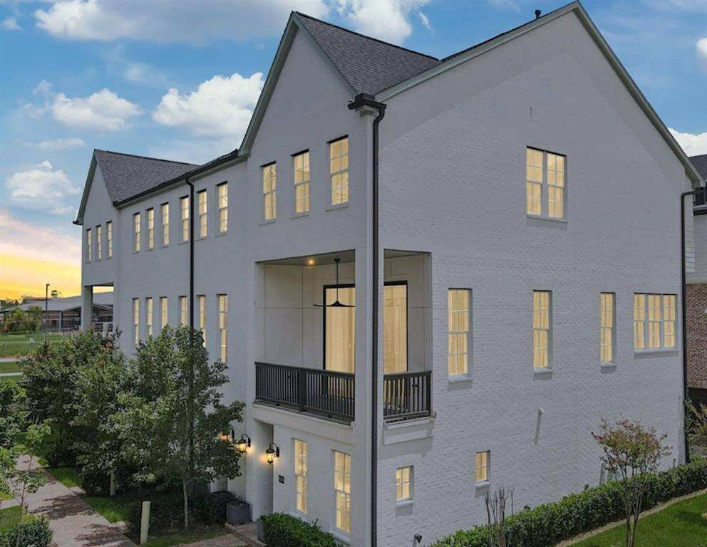 Bright, inviting exterior with a timeless white brick finish.