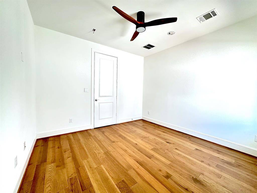 With new wood floors and its own full bathroom and walk-in closet, this secondary bedroom on the third level offers ultimate privacy and comfort.