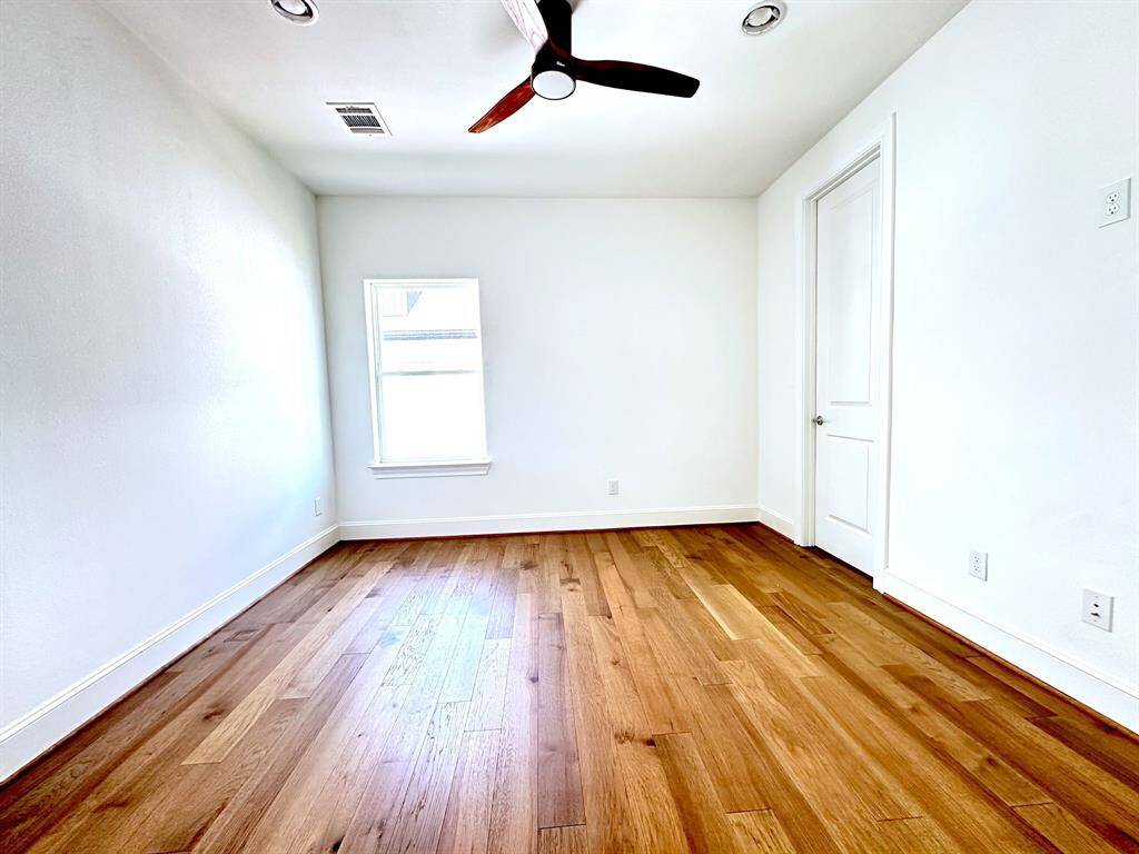 With new wood floors and its own full bathroom and walk-in closet, this secondary bedroom on the third level offers ultimate privacy and comfort.