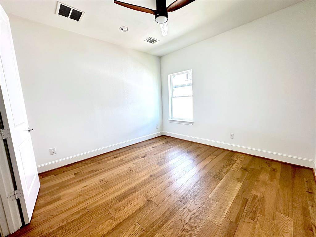 With new wood floors and its own full bathroom and walk-in closet, this secondary bedroom on the third level offers ultimate privacy and comfort.