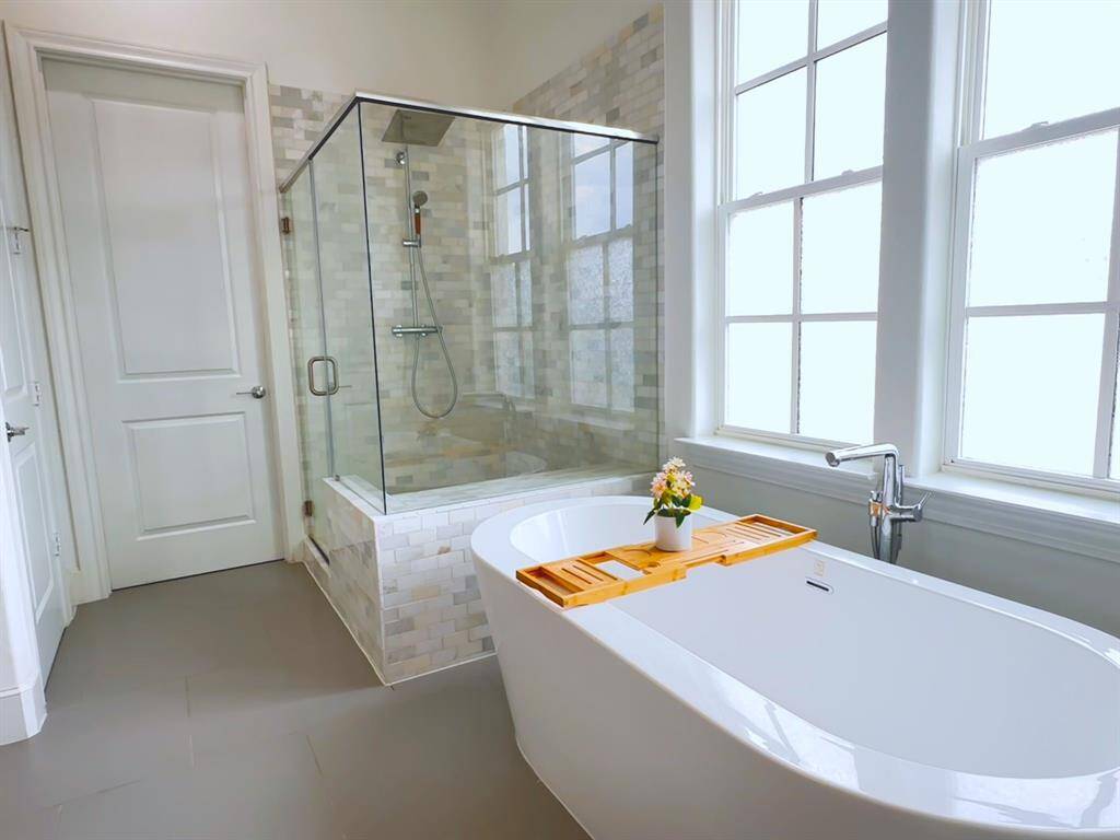 Luxurious and spacious. This primary bathroom features a freestanding tub, a separate shower, and double sinks, creating a spa-like retreat.