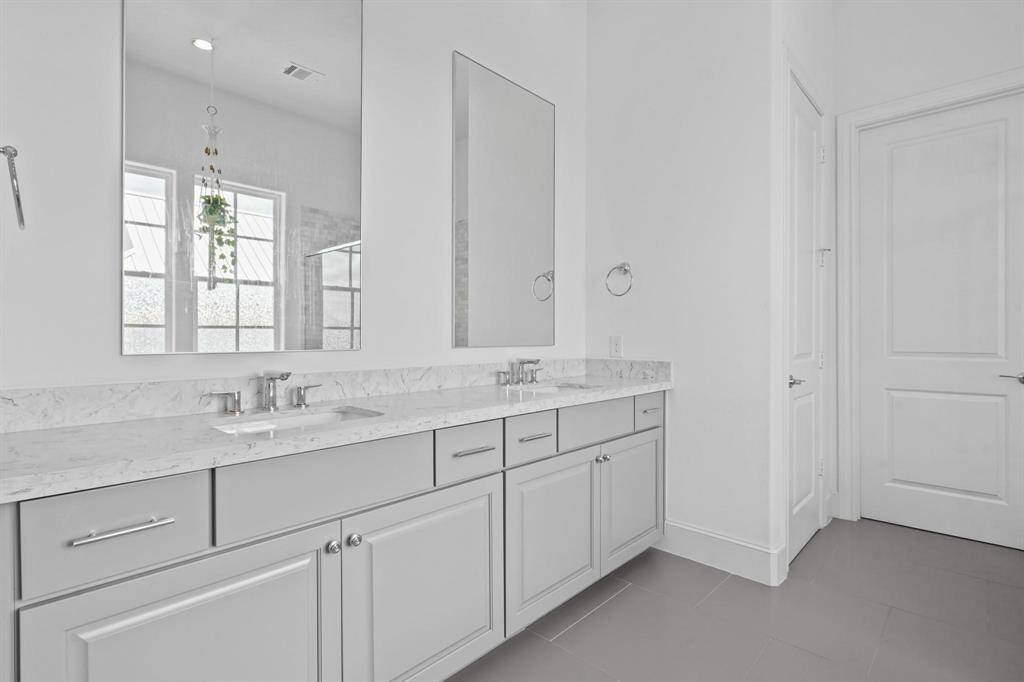 Luxurious and spacious. This primary bathroom features a freestanding tub, a separate shower, and double sinks, creating a spa-like retreat.