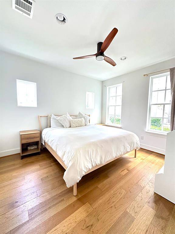 This first-floor bedroom features brand-new wood floors, complete with a full bath and walk-in closet, is ideal for guests or as a private retreat