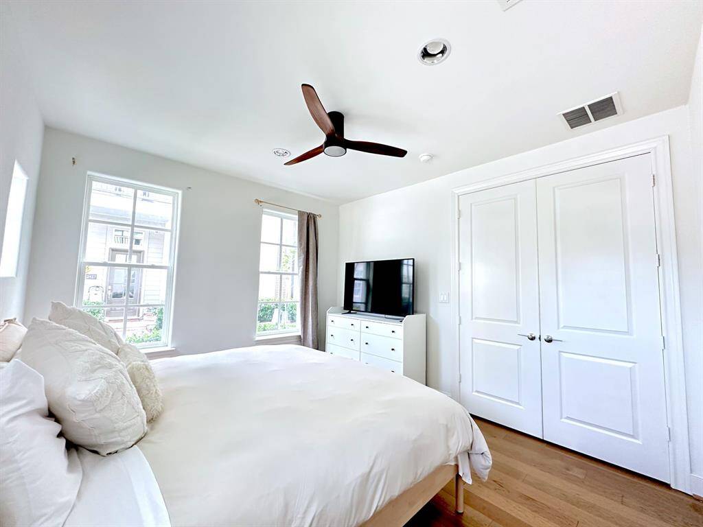 This first-floor bedroom features brand-new wood floors, complete with a full bath and walk-in closet, is ideal for guests or as a private retreat