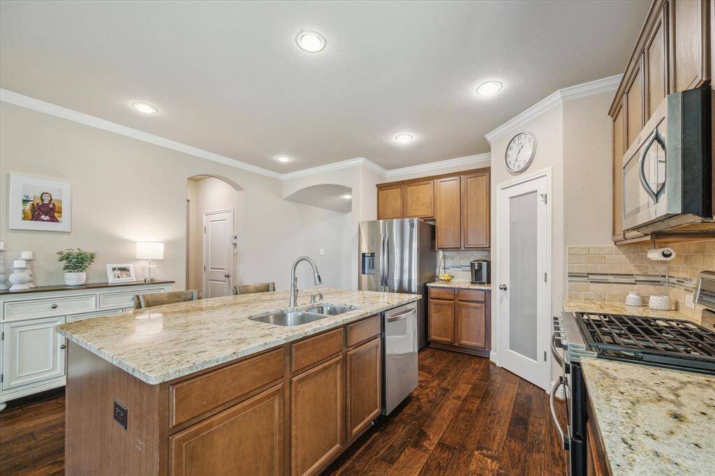This kitchen has a spacious island with a sink, space for seating and the perfect place for conversing with the cook. Large walk in pantry and ample counter/prep space for the chef.