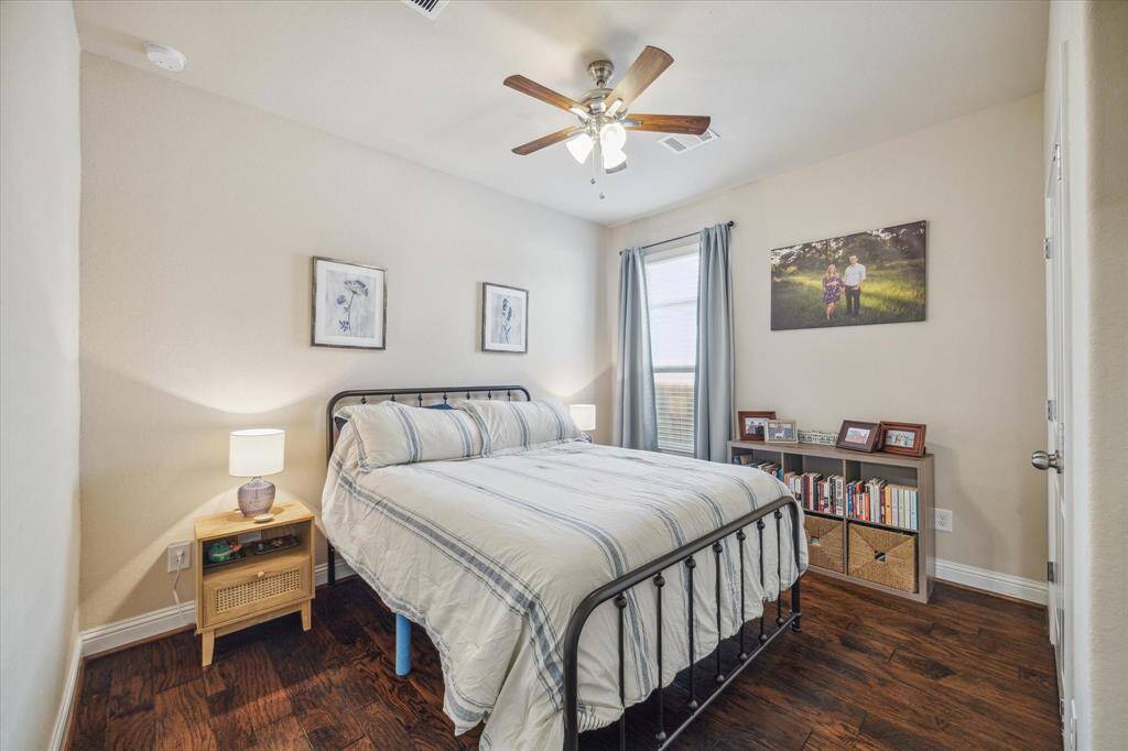 This secondary bedroom (#2) located on the first floor with full bathroom in the hallway outside.  Great for guests or those that do not want to navigate stairs.  No carpet - same gorgeous hardwood floors spilling in from the living area.  Neutral paint and soft colors with large closet.