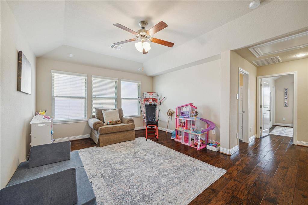 This bright and spacious room features hardwood floors, wall of windows and neutral paint. An ideal space for family gatherings, a children's playroom, secondary home office or flex space for workouts.