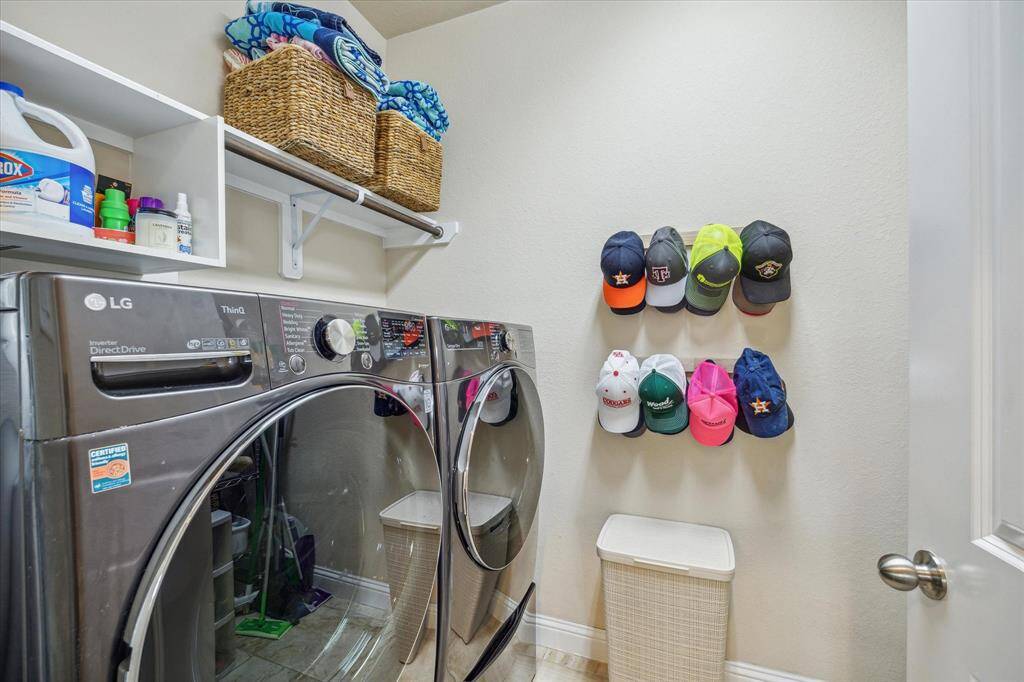 Laundry room with additional storage, hanging space, hooks and shelves.