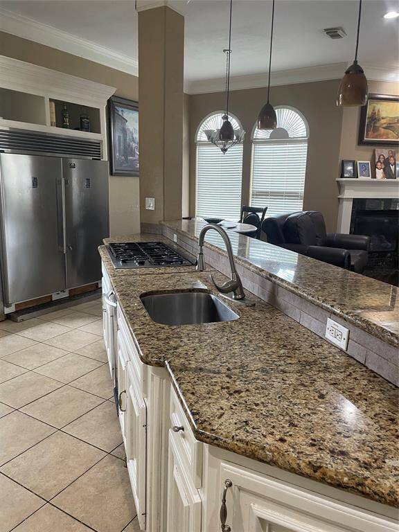 Built-in Refrigerator and extended bar overlooking the family room/den
