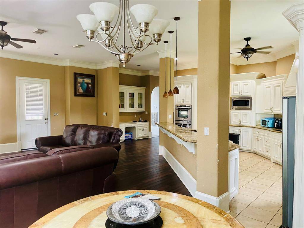 Crown moulding throughout, hardwood floors, built-in desk area off of the kitchen