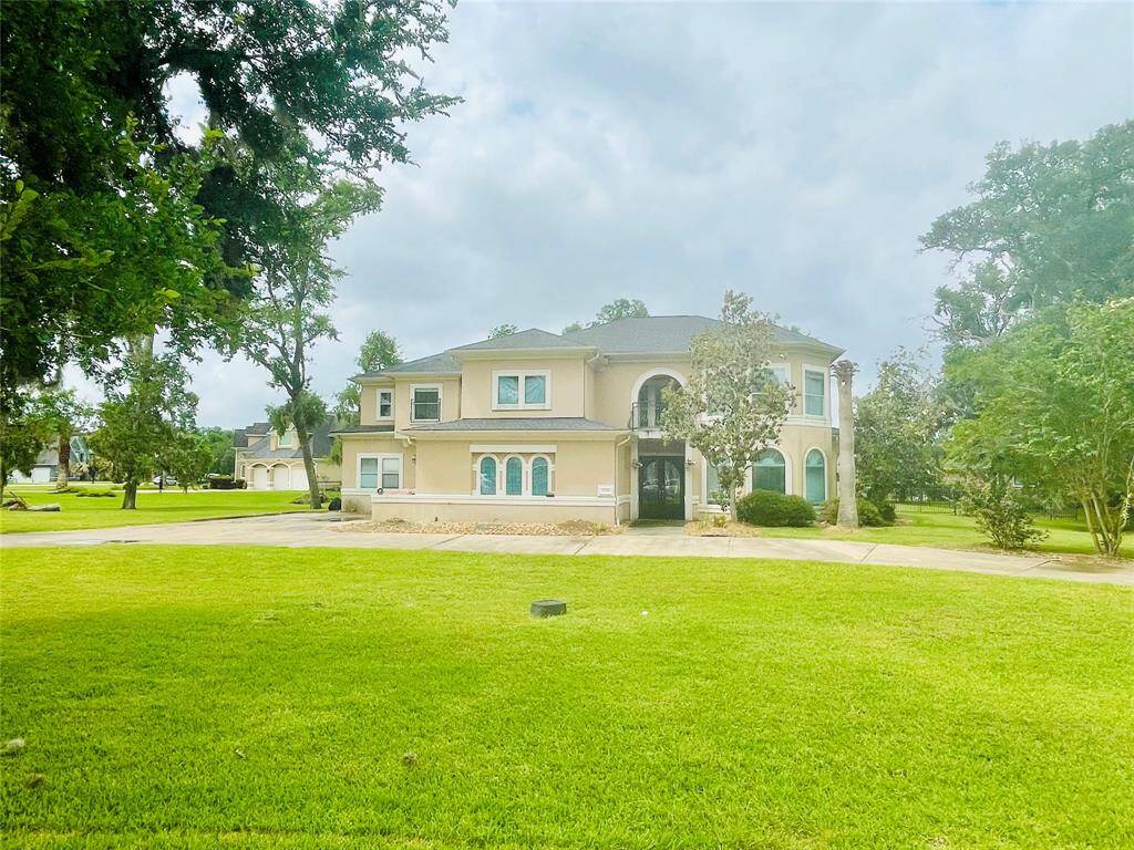 Front of the home.  Expansive front yard with circular drive.