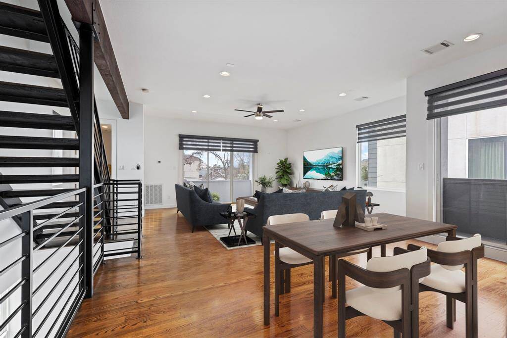 Dining table and living area are virtually staged.