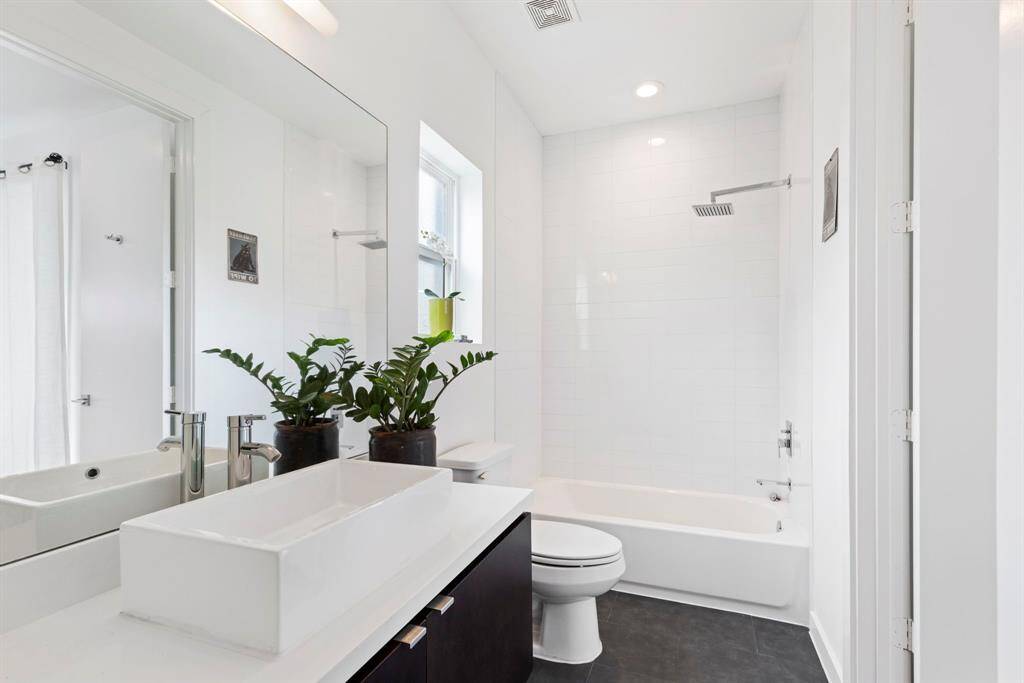 First floor bath. Stylish clean lines, espresso cabinets continue. Closet is pleasingly spacious.