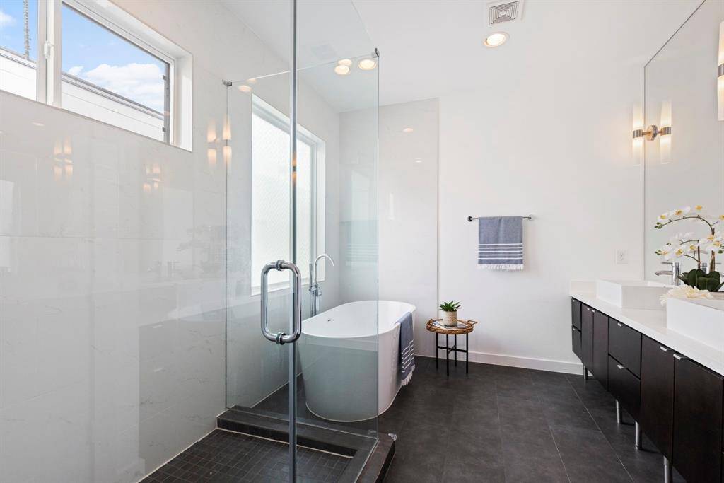 Separate frameless shower, sleek designs. Plenty of natural light.