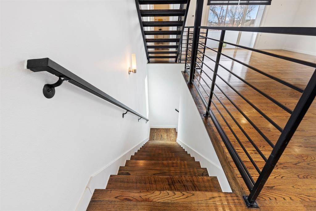 Architectural highlights include steel staircase and solid hardwood flooring throughout the home.