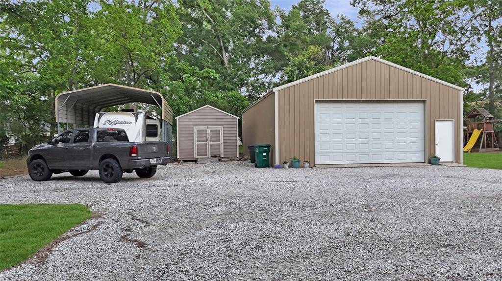 Covered RV parking, storage shed, plus garage!