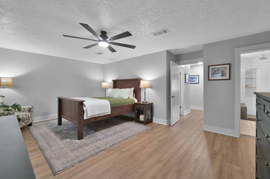 The primary bedroom with en suite bath and two walk in closets.
