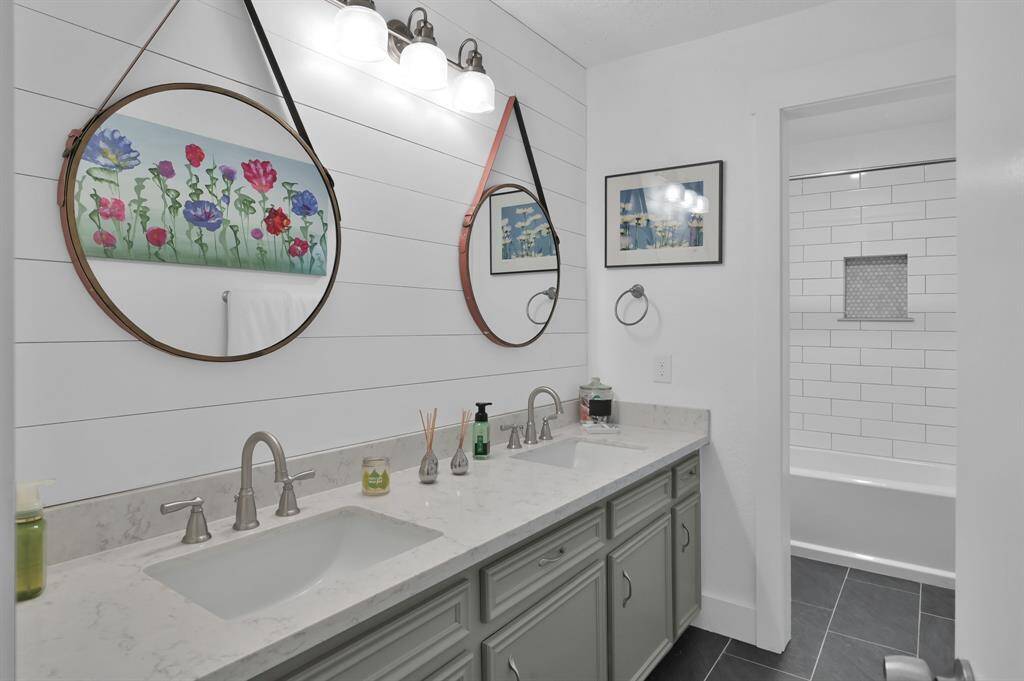 The second full bath is country chic with shiplap and subway tile.  Two sinks make getting ready in the mornings a breeze.