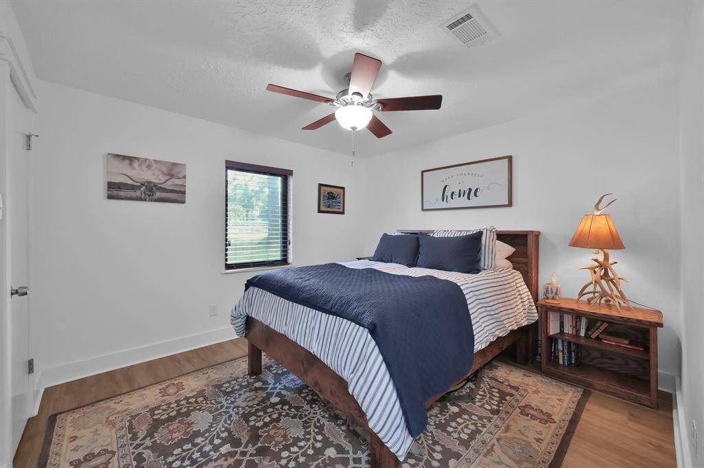 Third bedroom or guest room with scenic trees through the front window.