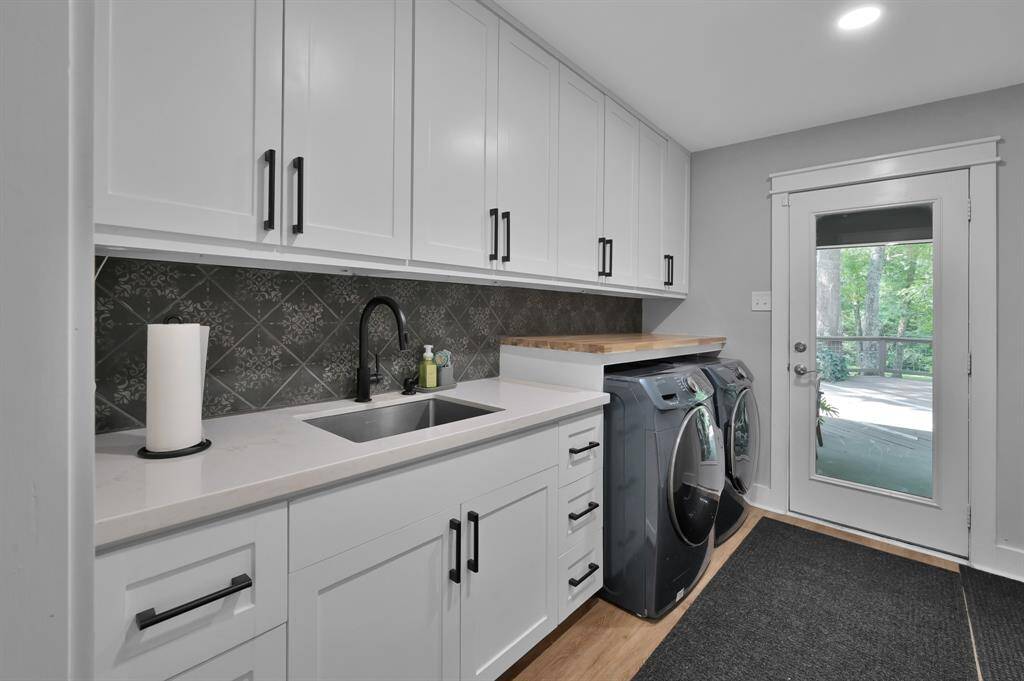 Your dream laundry room with custom cabinets and new countertops and lighting. The splash of color on the backsplash add whimsy to the room.   If you must do laundry, do it in style.